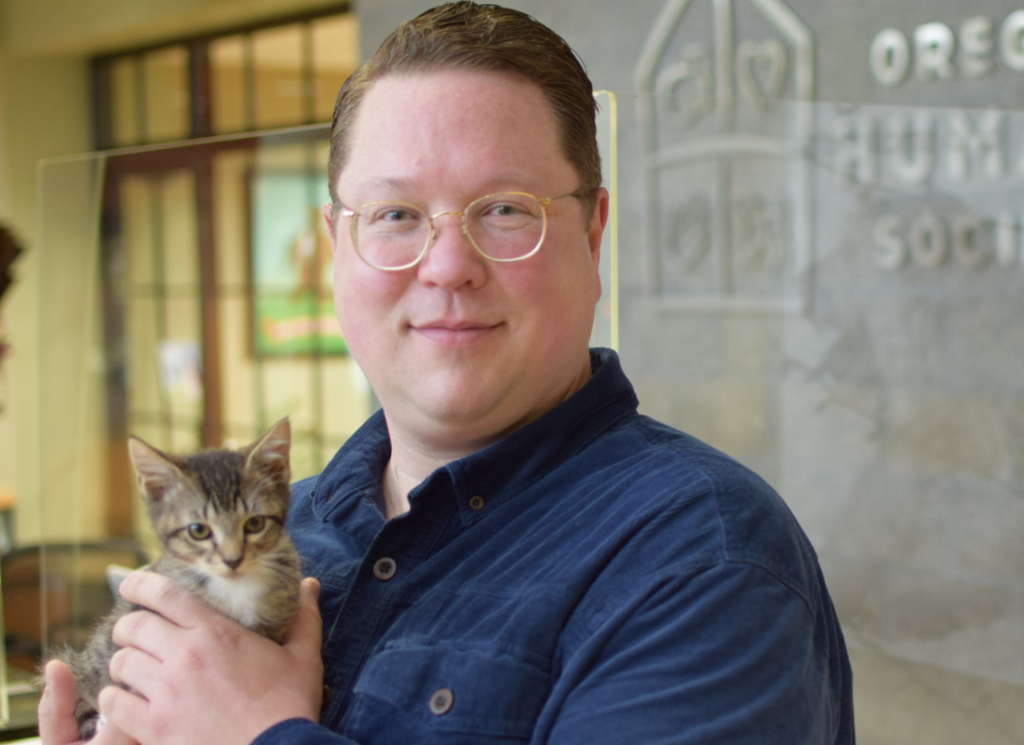 Photo of James Jacobus holding a shelter kitten